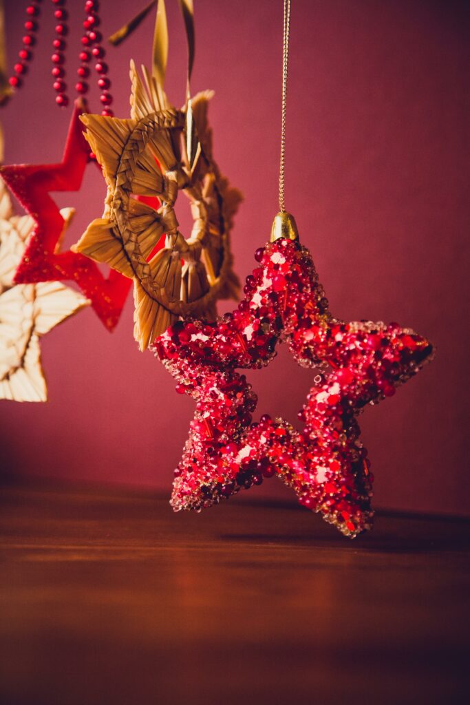 Close-up of shimmering Christmas star ornaments in warm hues, creating a festive ambiance.